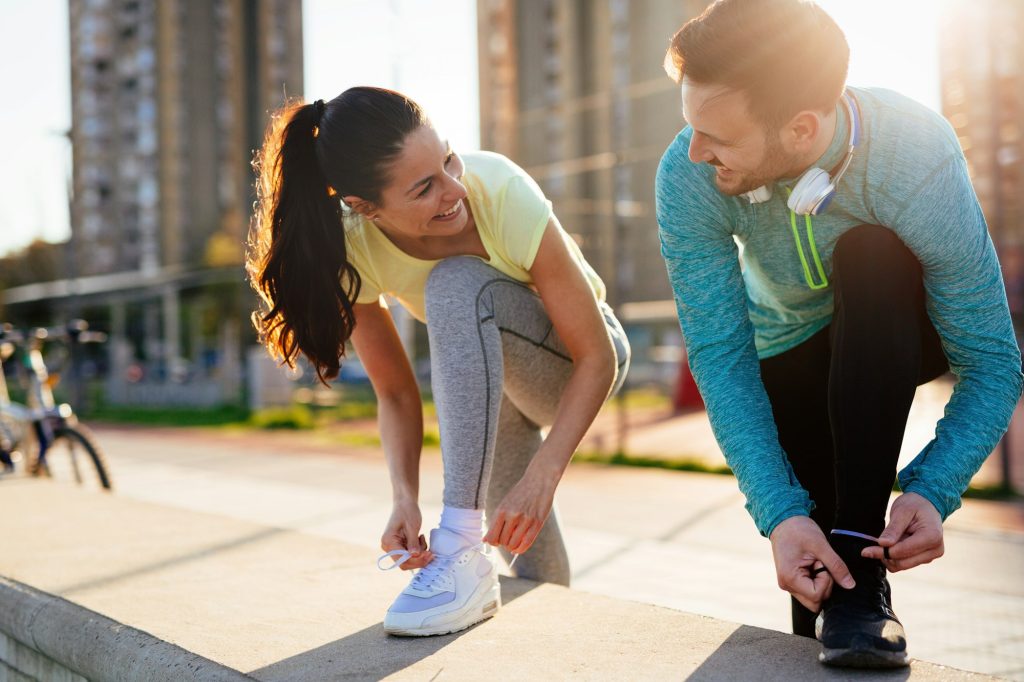 Runners tying running shoes and getting ready to run