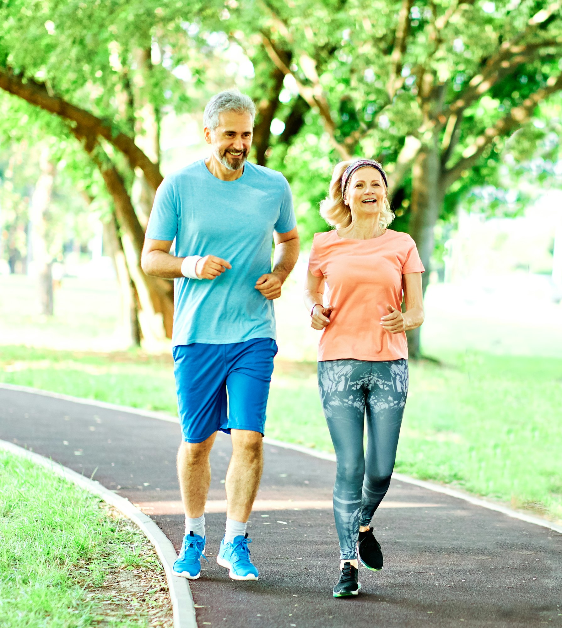 woman senior man outdoor running couple lifestyle sport smiling together jogging