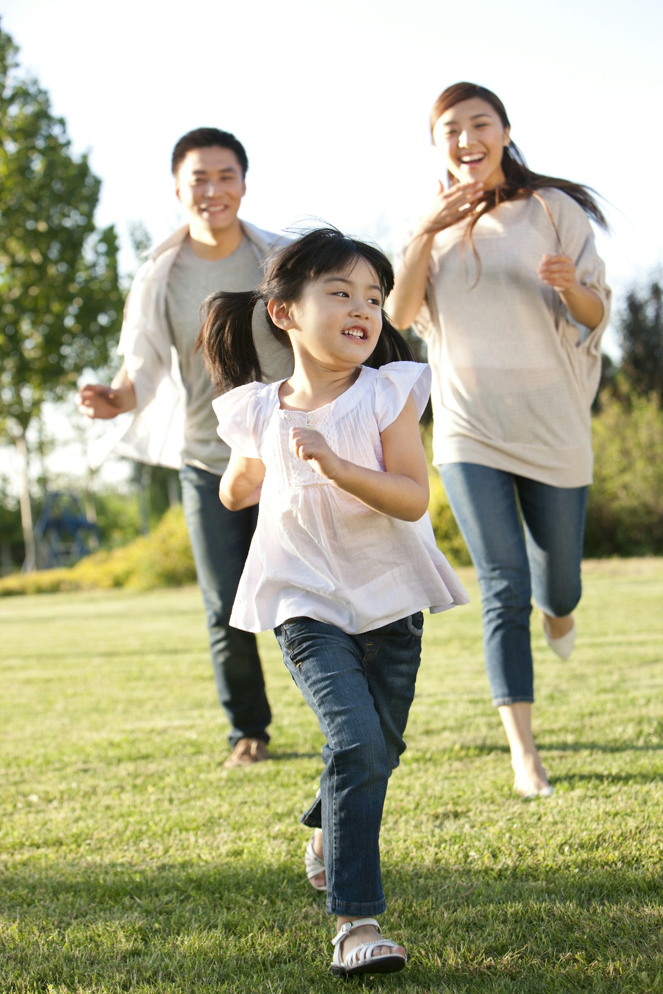 Young family running in a field